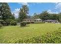 Expansive front yard showcasing a well-maintained lawn and a classic brick home at 4125 Lindsey Dr, Decatur, GA 30035