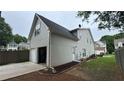 A side view of a house with a two car garage in the fenced backyard at 636 Lantern Park Ln, Scottdale, GA 30079