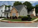 A well-maintained house with stone accents, tidy landscaping, and a neatly manicured lawn at 636 Lantern Park Ln, Scottdale, GA 30079