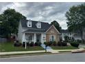 Attractive home featuring a stone facade, landscaped front yard, and inviting entrance, with an excellent curb appeal at 636 Lantern Park Ln, Scottdale, GA 30079