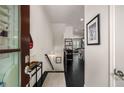 Modern home entryway with black hardwood floors, white walls and decor at 1661 Hammock Dr, Smyrna, GA 30080