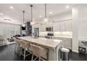 Open kitchen with an island, pendant lighting, and stainless appliances at 1661 Hammock Dr, Smyrna, GA 30080