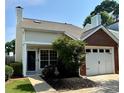 Charming home featuring mixed siding, attached garage, manicured landscaping, and a welcoming front entry at 1822 Commonwealth Dr, Woodstock, GA 30188