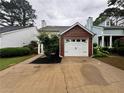 Charming townhouse with a one-car garage, well-maintained lawn, and inviting curb appeal at 1822 Commonwealth Dr, Woodstock, GA 30188