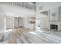 Spacious living room with a fireplace, spiral staircase, and stylish flooring for a modern touch at 1822 Commonwealth Dr, Woodstock, GA 30188