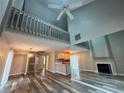 Bright and airy living room featuring high ceilings, fireplace, and wood-look flooring at 1822 Commonwealth Dr, Woodstock, GA 30188