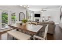 Bright dining area with a large wooden table, stylish seating, and seamless flow to the adjacent living room at 2127 Apple Orchard Way, Austell, GA 30168
