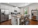 Modern kitchen with stainless steel appliances, granite countertops, and a functional center island with barstool seating at 2127 Apple Orchard Way, Austell, GA 30168