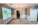 Traditional dining room with wainscoting and a chandelier at 4676 Shaded Oak Ln, Forest Park, GA 30297