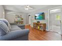 Living room with hardwood floors, comfortable seating, and a mounted television at 118 Greenwood St, Fairburn, GA 30213