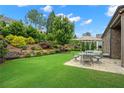 Beautiful outdoor patio with an umbrella and furniture overlooking the grassy landscaped yard at 2115 Creekstone Point Dr, Cumming, GA 30041
