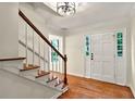 Inviting foyer with hardwood floors, staircase, and a bright white front door at 3564 Liberty Ln, Marietta, GA 30062