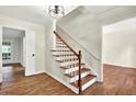 Elegant foyer with hardwood floors, staircase, and crisp, neutral paint at 3564 Liberty Ln, Marietta, GA 30062