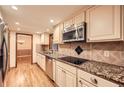 Modern kitchen with stainless steel appliances, granite countertops, and tile backsplash at 421 Fond Du Lac Dr, Stone Mountain, GA 30088