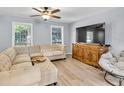 Bright living room featuring a large sectional sofa, mounted TV, and stylish furnishings at 7307 Cardigan Cir, Sandy Springs, GA 30328