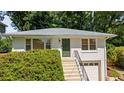 Beautiful home with a striking front door, lush green foliage, and a convenient one-car garage at 80 Vinson Se Dr, Atlanta, GA 30317
