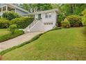 Beautiful two-story house showcasing manicured lawn, lush landscaping, and convenient attached garage at 80 Vinson Se Dr, Atlanta, GA 30317