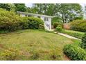 View of a lush front yard with mature trees and landscaping, complemented by a charming white house at 80 Vinson Se Dr, Atlanta, GA 30317
