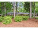 Secluded brick home nestled among mature trees with lush landscaping and a serene setting at 302 Chinquapin Sw Dr, Marietta, GA 30064