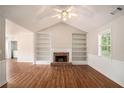 Bright living room with hardwood floors, fireplace, and built-in bookshelves at 75 Plantation Ln, Locust Grove, GA 30248