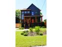 Inviting two-story home boasts a covered porch, wood accents, and lush landscaping at 1122 Rice Nw St, Atlanta, GA 30318
