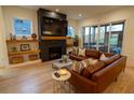 Cozy living room featuring a stone fireplace, floating shelves, and sliding glass doors to an outdoor patio at 1122 Rice Nw St, Atlanta, GA 30318