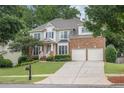 Lovely two-story home with brick and siding, complemented by a lush lawn and a two-car garage at 1547 Trilogy Park, Hoschton, GA 30548