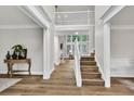 Spacious foyer featuring hardwood floors, high ceilings, and a staircase leading to the upper level at 1547 Trilogy Park, Hoschton, GA 30548