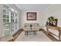 Bright living room with large windows, hardwood floors, and comfortable seating at 1547 Trilogy Park, Hoschton, GA 30548