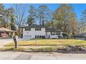 Charming home featuring a well-kept lawn, and contrasting black shutters, all set under a clear blue sky at 2178 Shamrock Dr, Decatur, GA 30032