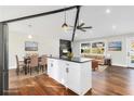 Open-concept kitchen features an island with a black countertop, stainless steel appliances, and wood floors at 2178 Shamrock Dr, Decatur, GA 30032