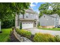 Stylish home boasts a two-car garage, complemented by lush landscaping and gray siding at 2573 Paul Nw Ave, Atlanta, GA 30318