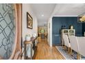 Inviting foyer with hardwood floors, decorative front door, and views into dining area at 2573 Paul Nw Ave, Atlanta, GA 30318