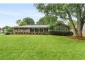 Inviting exterior view of home with a well-maintained lawn and classic brick facade at 2644 Hickory Valley Dr, Snellville, GA 30078