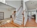 Bright foyer with hardwood floors, staircase, and an open view into the dining room at 1942 Westover Nw Ln, Kennesaw, GA 30152