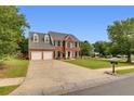 Charming home features a manicured lawn, driveway, and traditional brick facade at 1942 Westover Nw Ln, Kennesaw, GA 30152