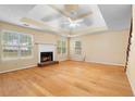 Spacious living room featuring a cozy fireplace, hardwood floors, and abundant natural light from large windows at 2881 Bridle Creek Sw Dr, Conyers, GA 30094