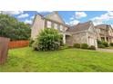 Side view of a two-story home with a brick facade and well-manicured lawn at 405 Highbranch Cir, Lawrenceville, GA 30044