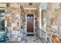Detailed stone facade highlights the front entrance and wood door at 4541 Gateway Se Ct, Smyrna, GA 30080