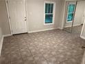Neutral bedroom featuring easy to maintain tile floor, closet, and bright natural light at 1829 Mercer, College Park, GA 30152