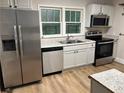 Modern kitchen with stainless steel appliances, granite countertops, and bright natural light at 1829 Mercer, College Park, GA 30152