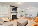 Comfortable living room with a fireplace, mounted TV, and an adjacent dining area, ideal for Gathering gatherings at 4120 Valley Wood Nw Dr, Marietta, GA 30064