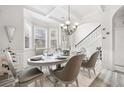 Bright dining room with decorative chandelier, wainscoting, and a bay window at 4608 Treasure Ct, Forest Park, GA 30297