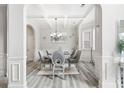Dining room with wainscoting detail, coffered ceilings, and luxury vinyl plank flooring at 4608 Treasure Ct, Forest Park, GA 30297
