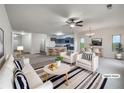 Open-concept living space with modern decor, seamlessly connecting living, dining, and kitchen areas at 6100 Semaphore Rdg, Rex, GA 30273