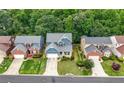 A view of a well-manicured neighborhood and a charming home at 1536 Fenmore St, Lithia Springs, GA 30122