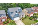 Aerial view of a two-story home with well-maintained landscaping and a gray roof at 1536 Fenmore St, Lithia Springs, GA 30122