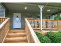 Inviting front porch with new wood stairs, white railing, and seating area at 123 Mill Ln, Dallas, GA 30157