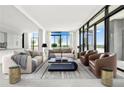 Bright living room featuring stylish furnishings, floor-to-ceiling windows and access to the outside terrace at 2425 Peachtree Ne Rd # 1503, Atlanta, GA 30305