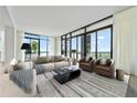 Bright and airy living room with floor-to-ceiling windows and sophisticated decor for upscale living at 2425 Peachtree Ne Rd # 1503, Atlanta, GA 30305